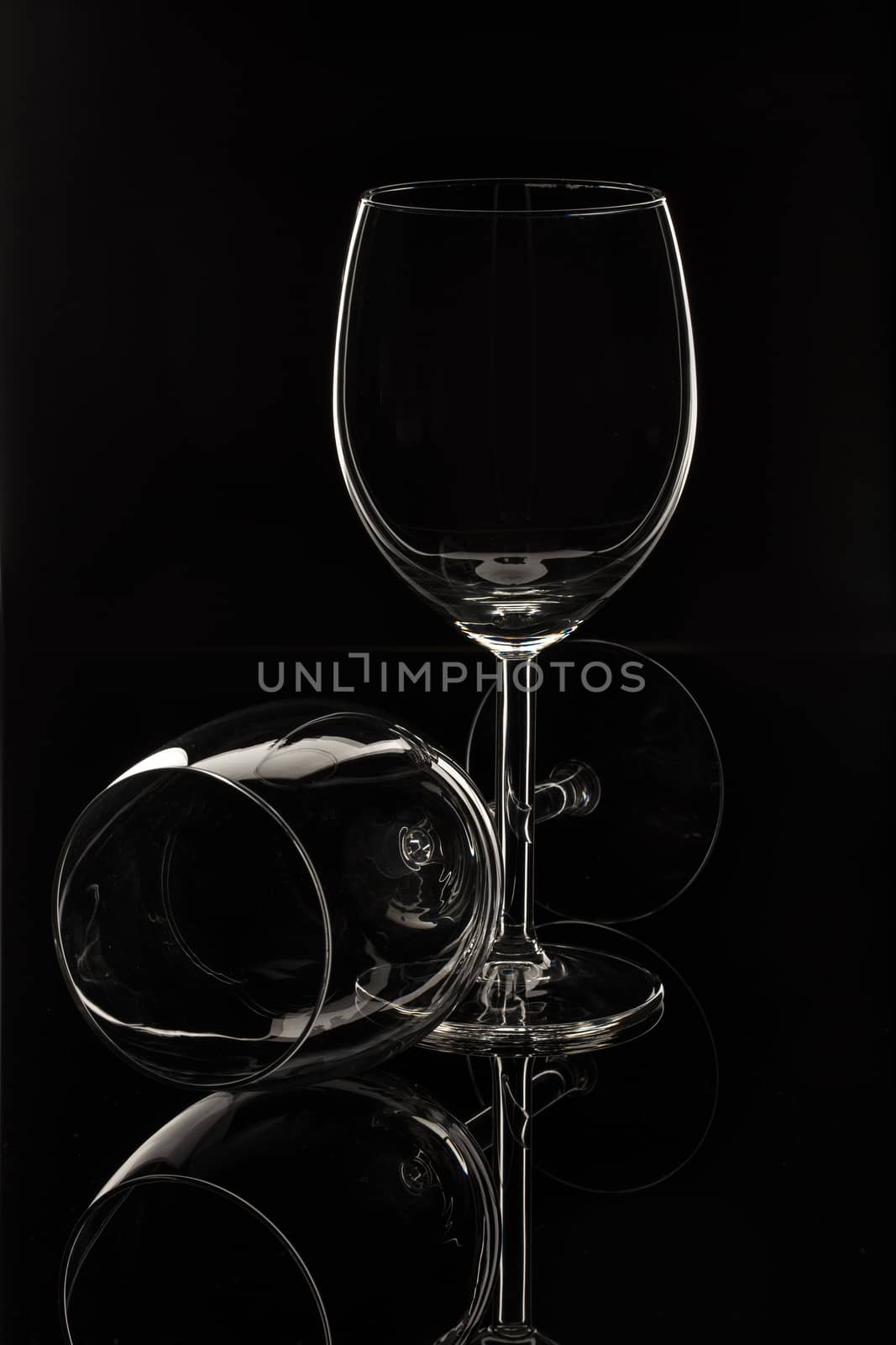 Wineglasses on glass reflecting background