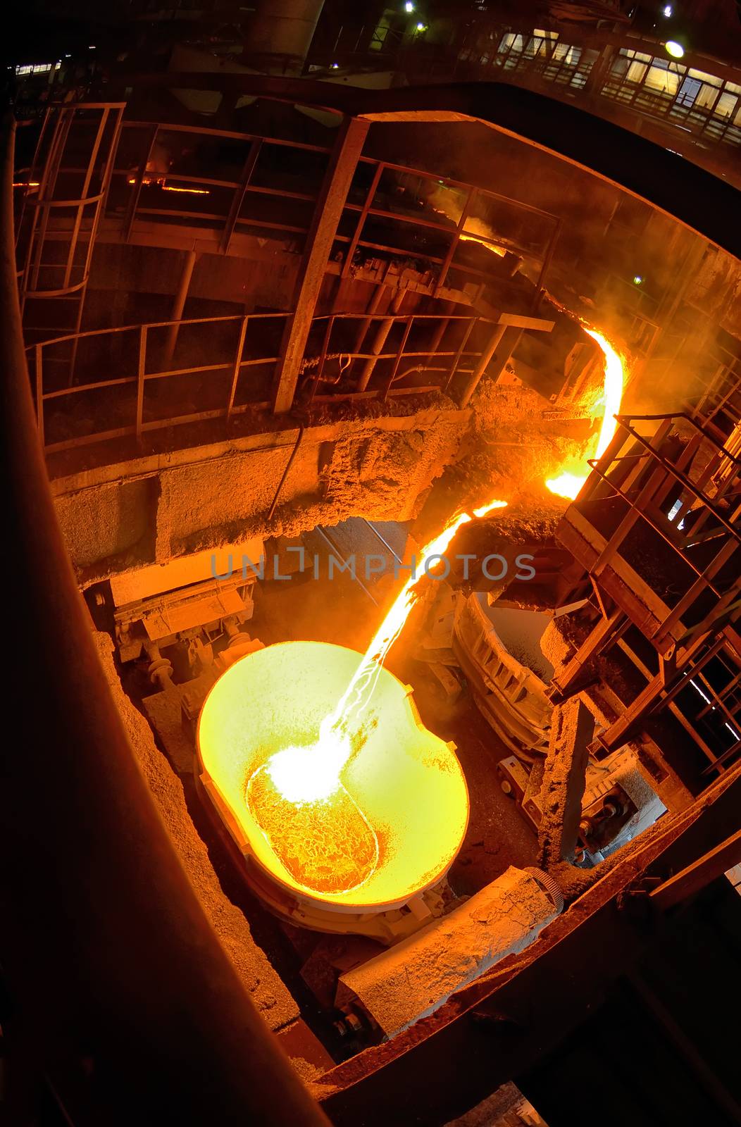 Hot steel pouring in ladle car train in steel plant