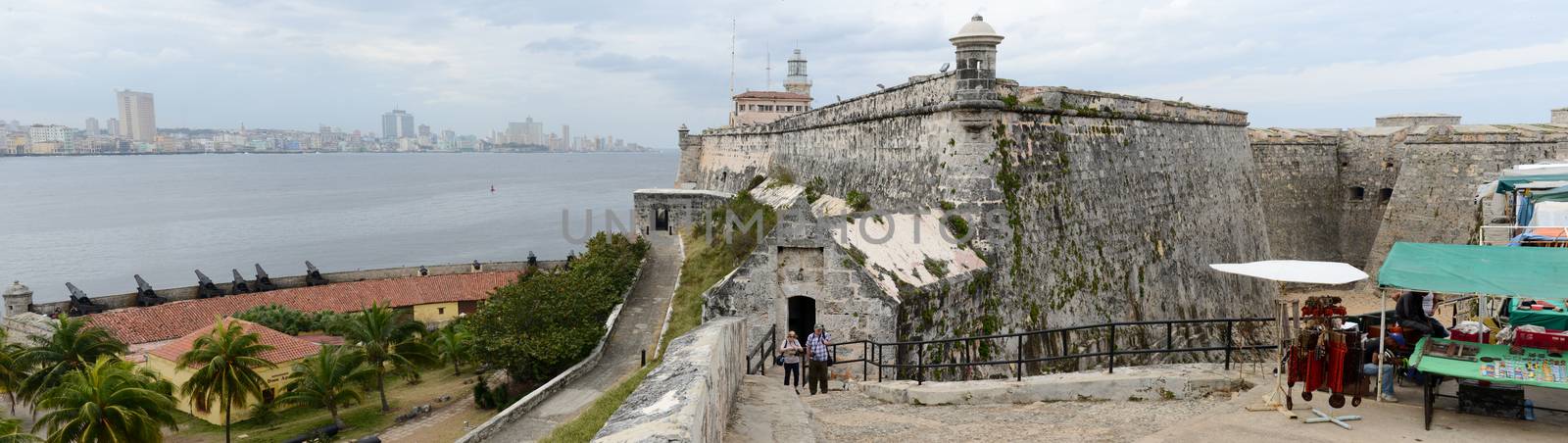 Havana, Cuba - 26 january 2016: People walking and taking picture in front of El Morro fortress with the city of Havana in the background, Cuba