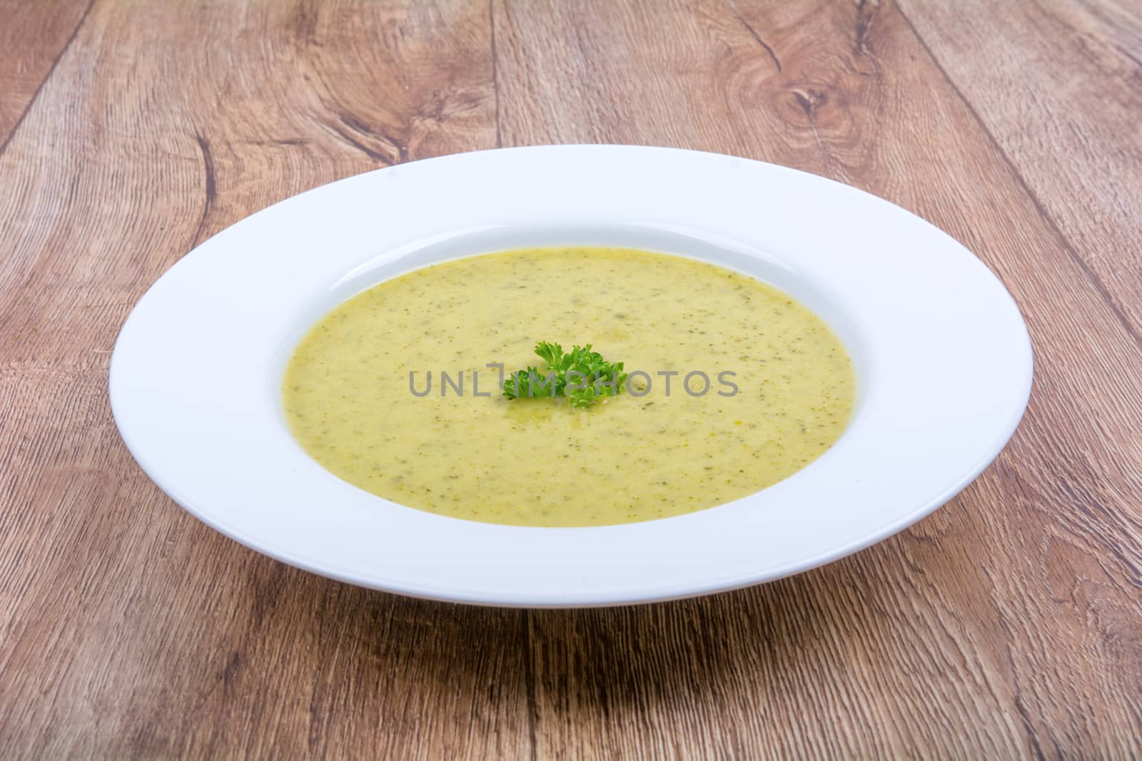 Cream of broccoli soup on a white plate