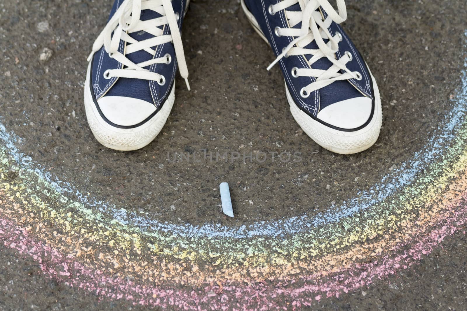 Legs in sneakers on the pavement before drawn a rainbow by sergeizubkov64