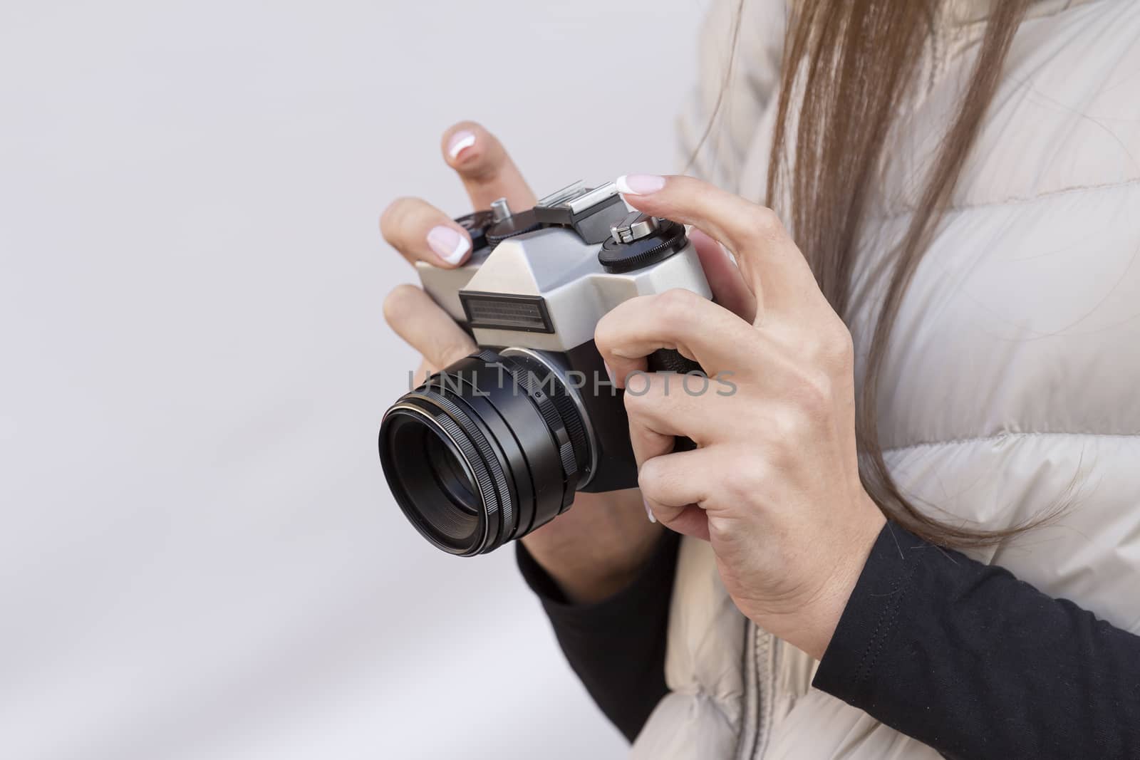 the girl in the hands of is holding the vintage camera