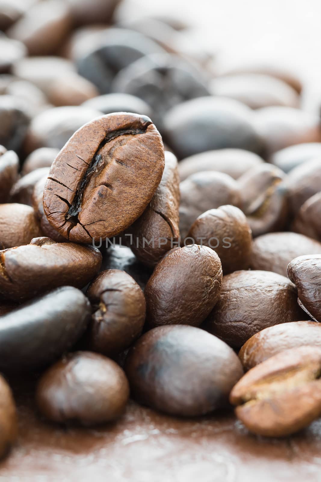 Close up heap of roasted brown coffee beans