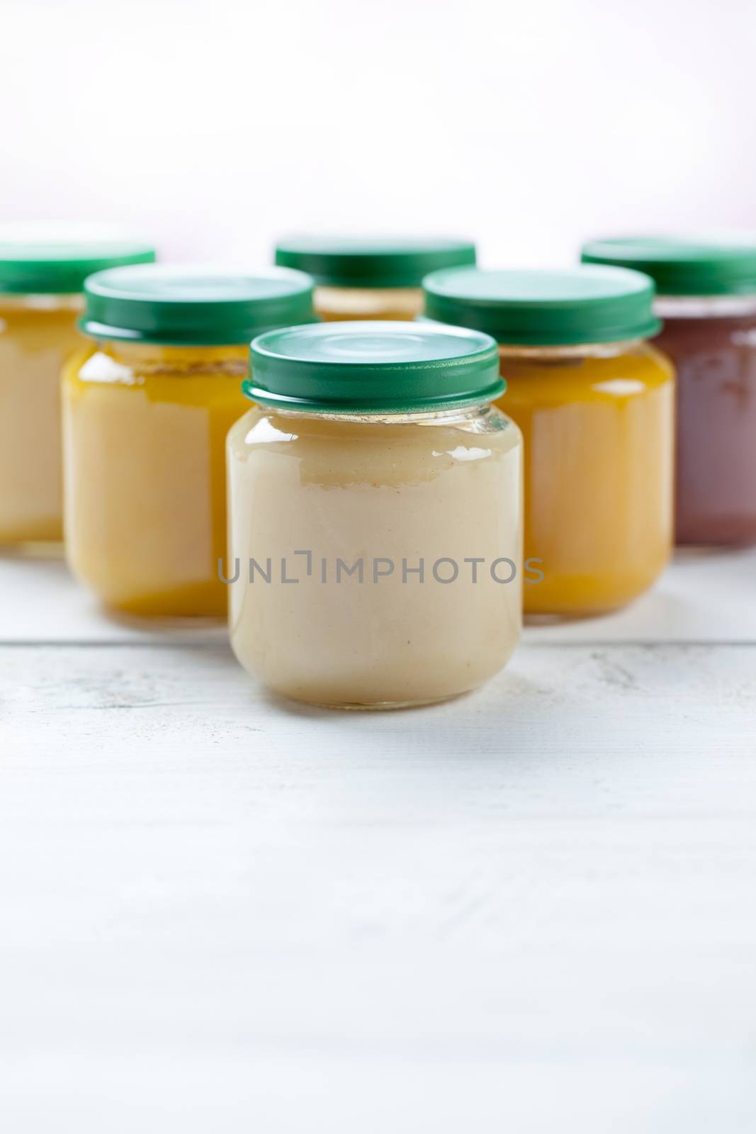 healthy ready-made baby food on a wooden table.