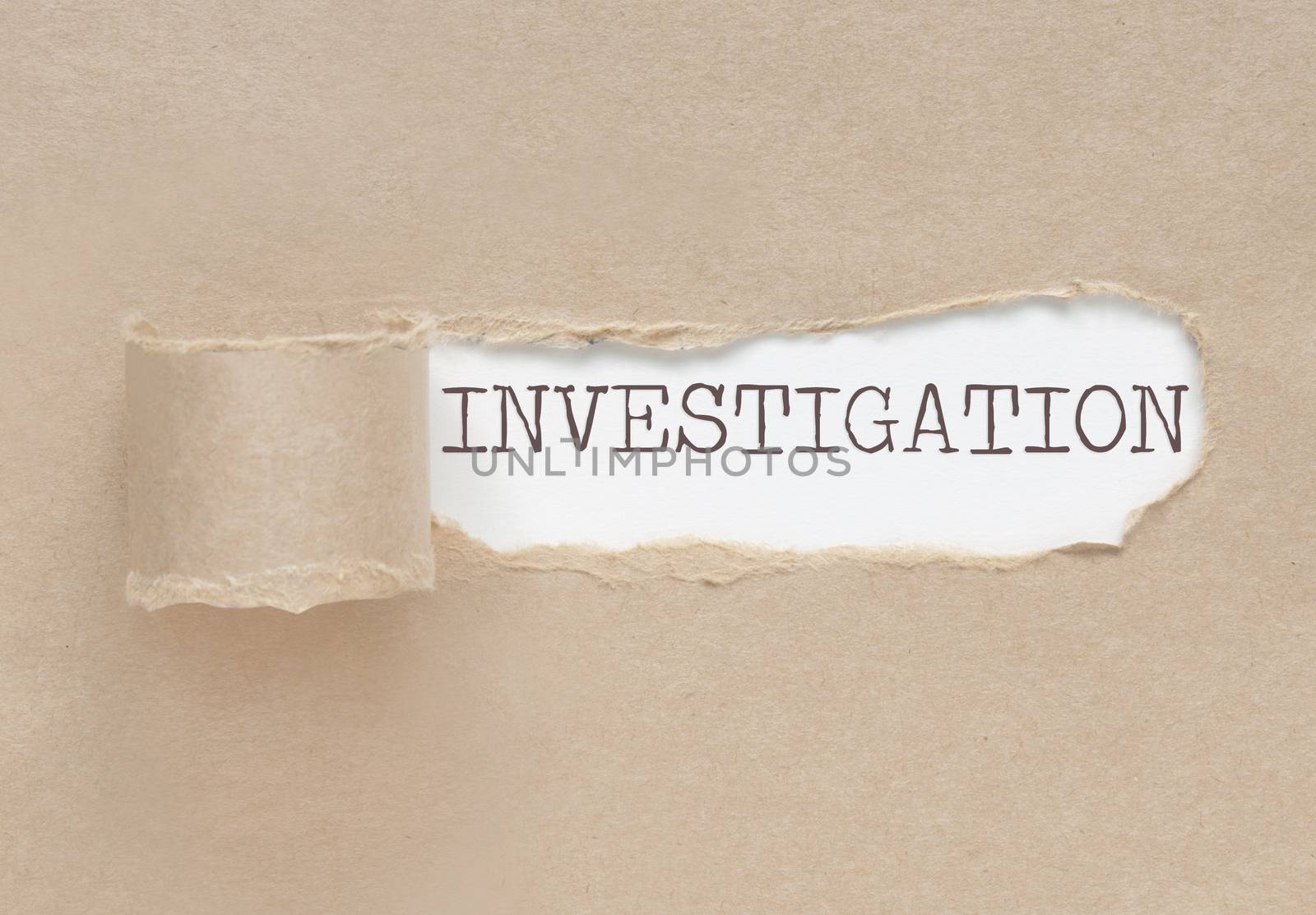 Torn paper revealing the word investigation underneath