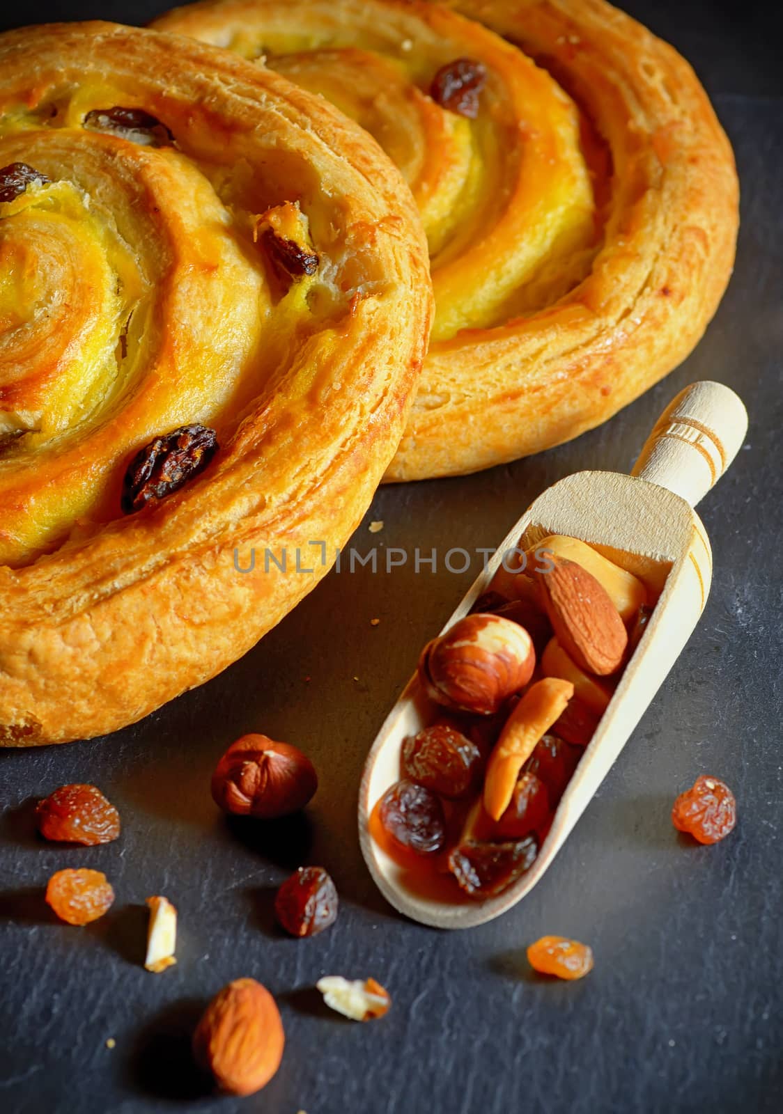 Round shape fresh croissant filled with vanilla cream and raisins