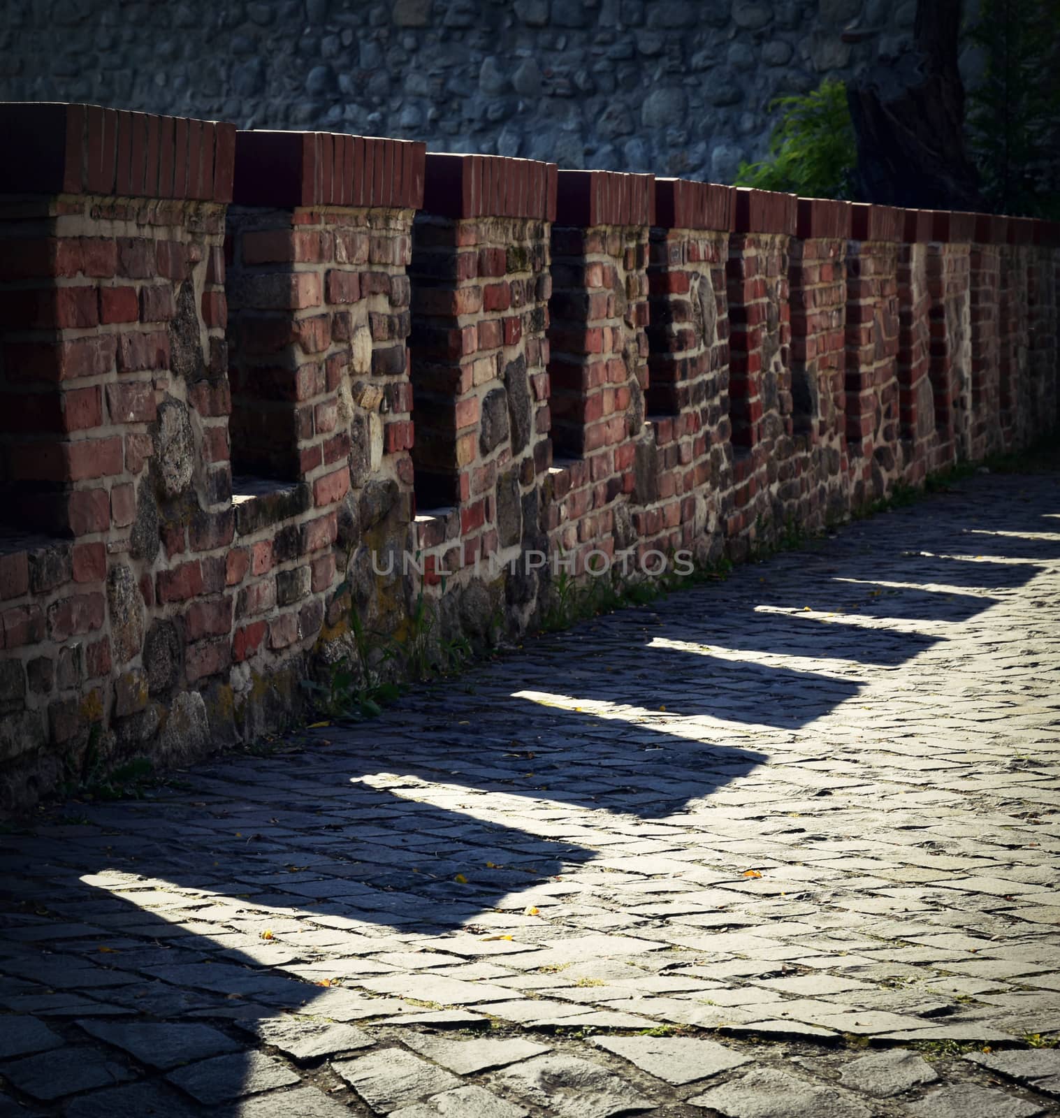 old defensive brick wall with shadow by Ahojdoma