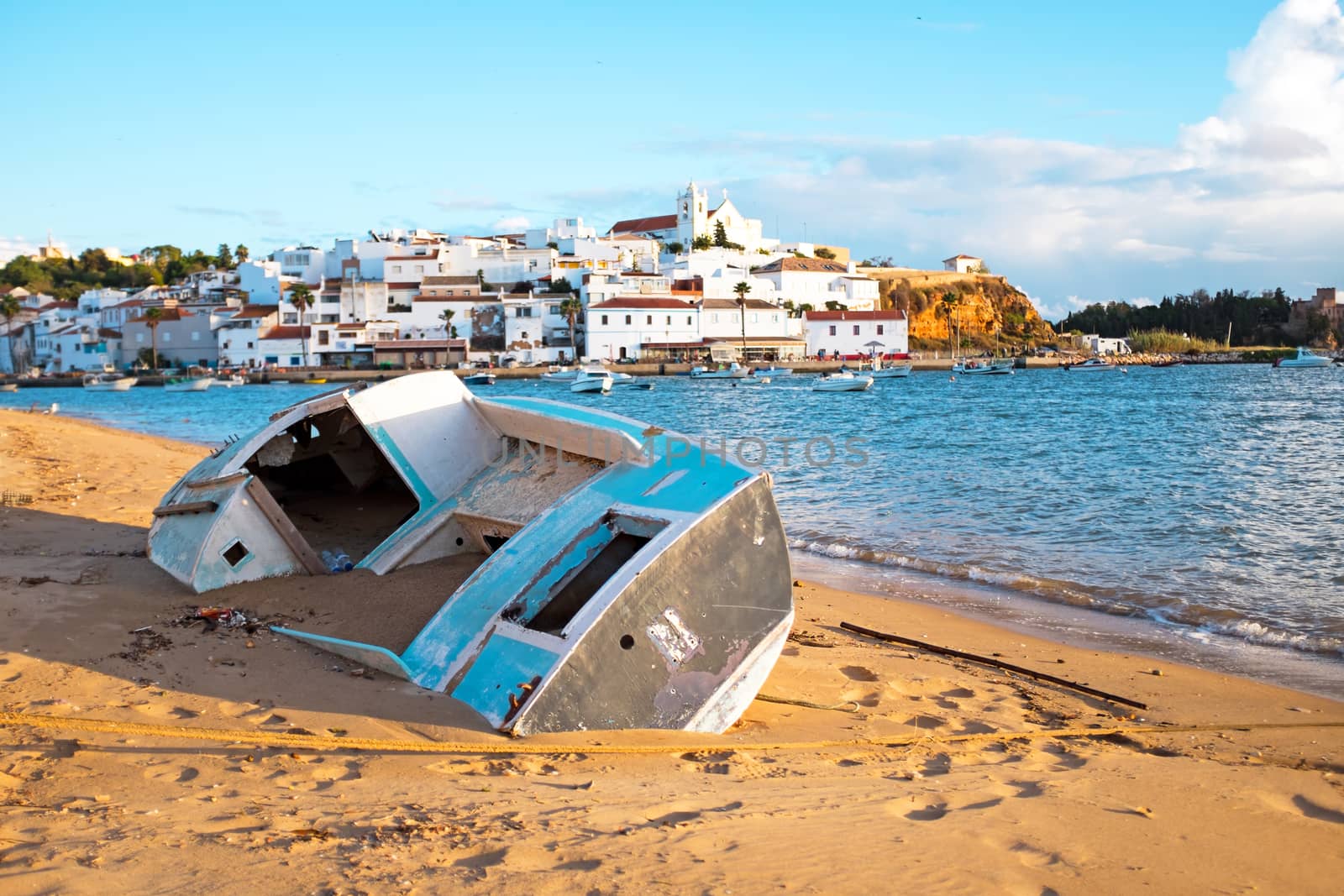 Old fisherman's boat at the beach near Ferragudo in the Algarve Portugal