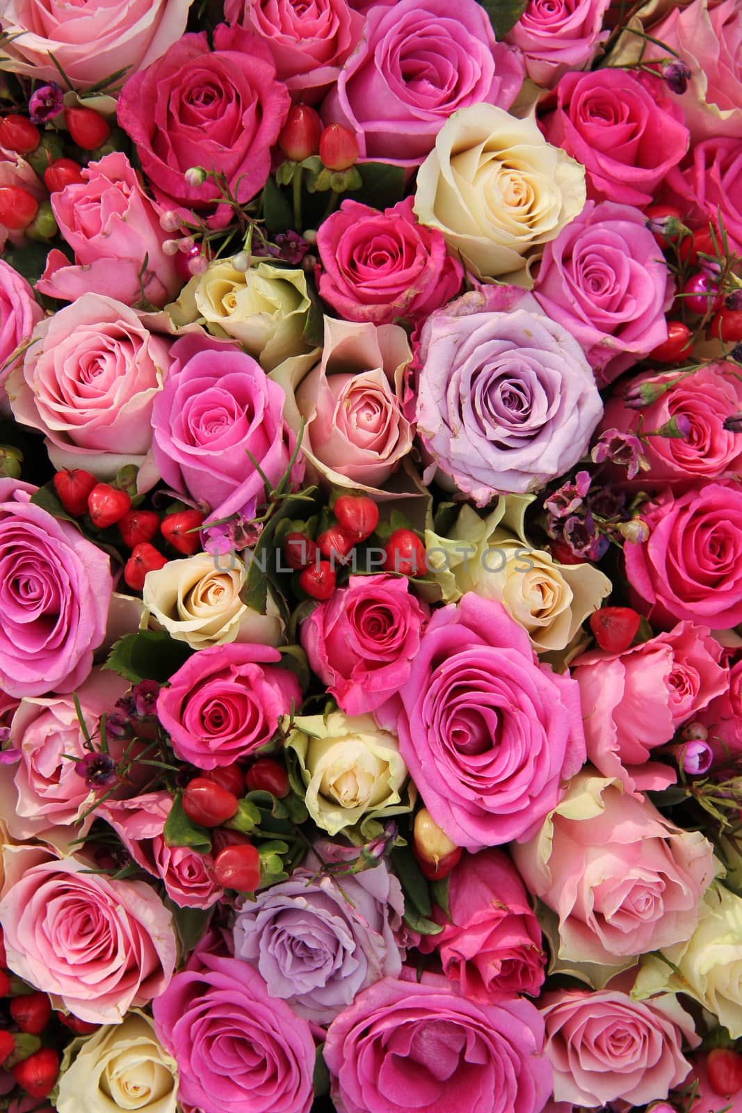 Various shades of pink roses in a wedding centerpiece