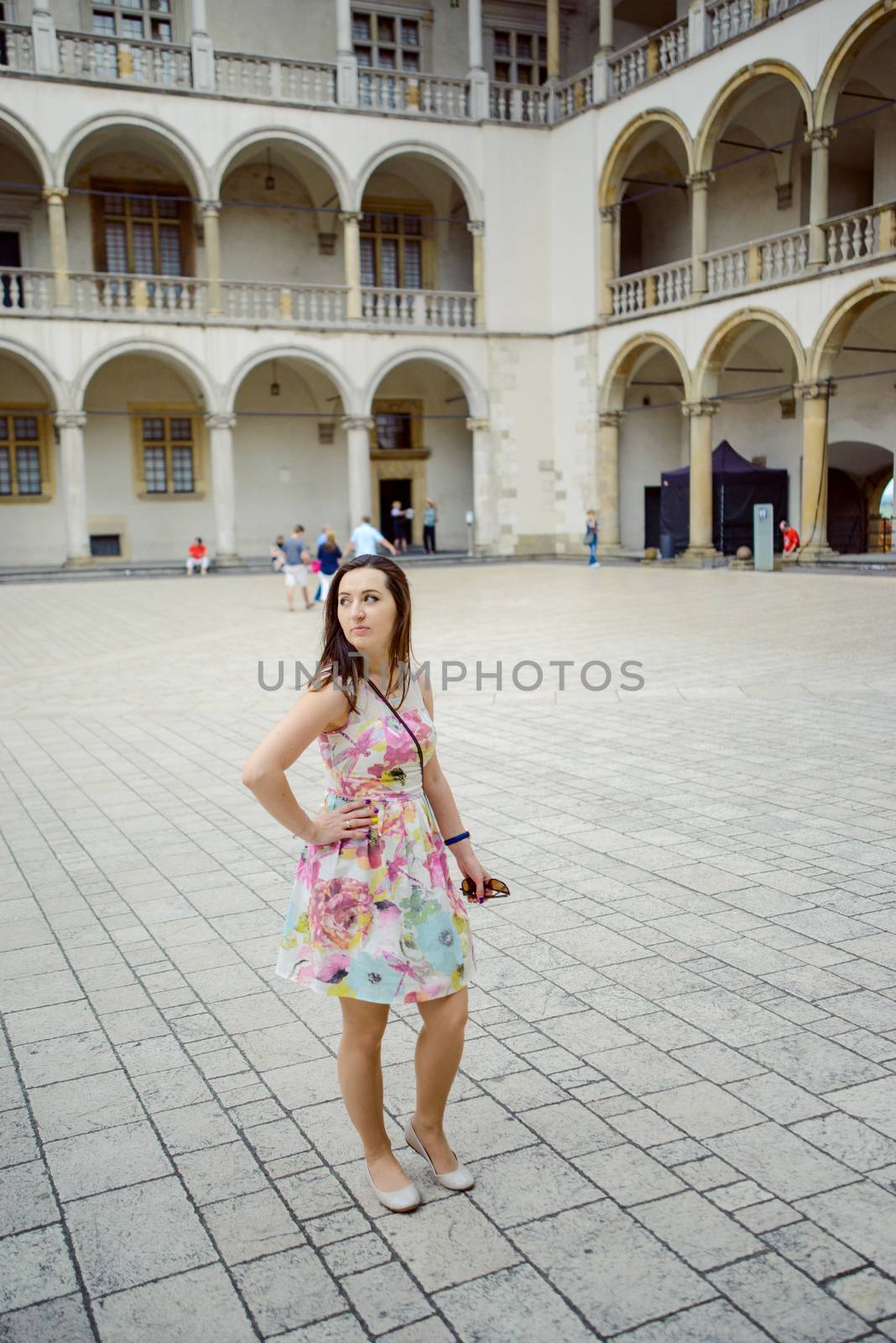 Beautiful girl during sightseeing old castle in Cracow, Wawel. by Brejeq