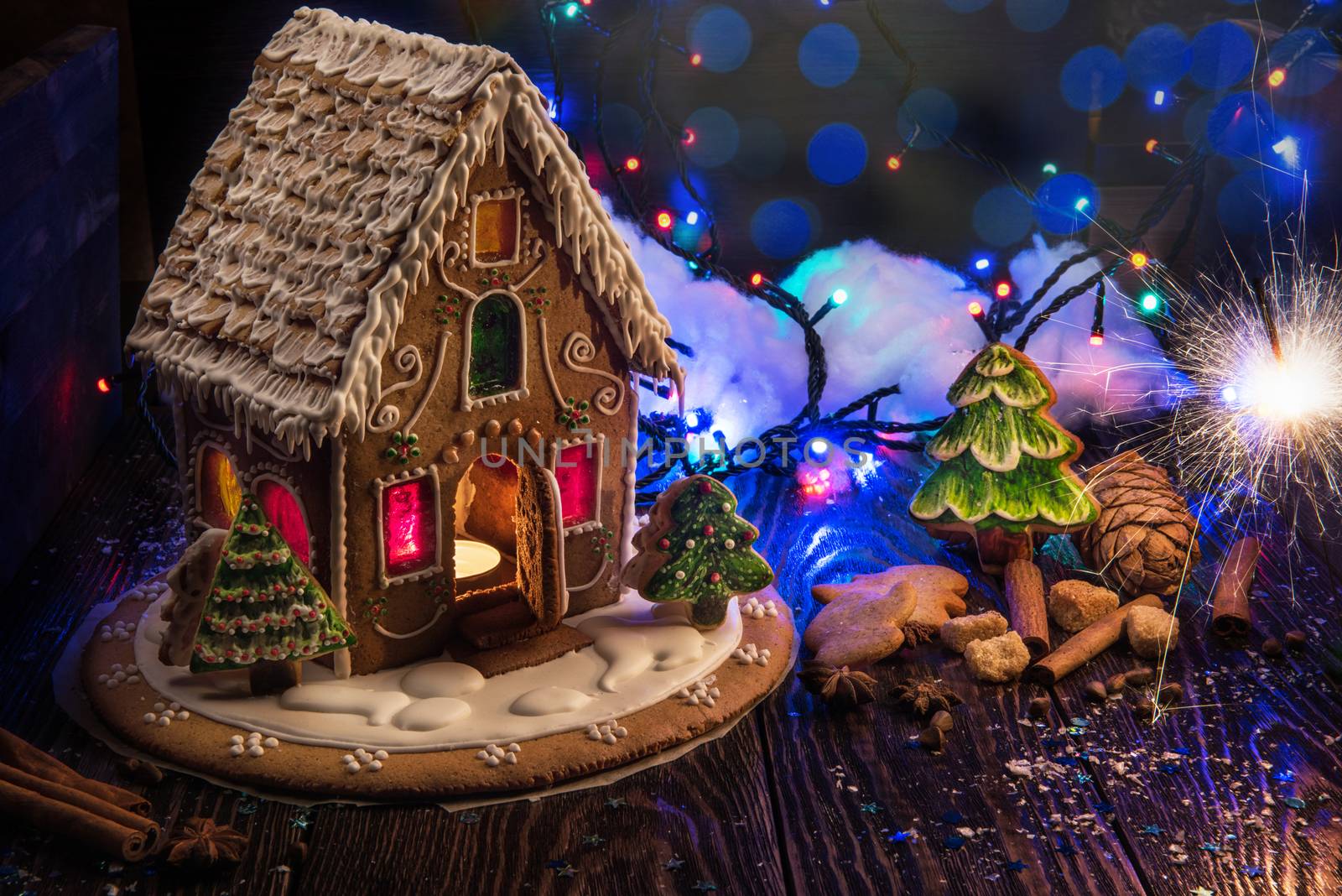 Gingerbread house with lights on dark background, xmas theme