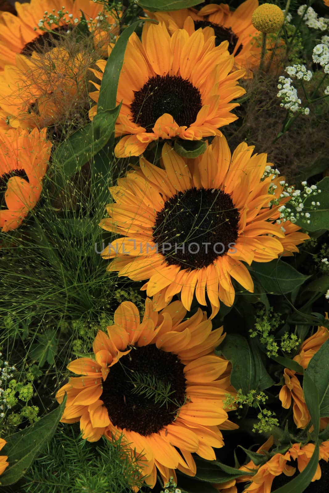 Big yellow sunflowers in a wedding floral arrangement