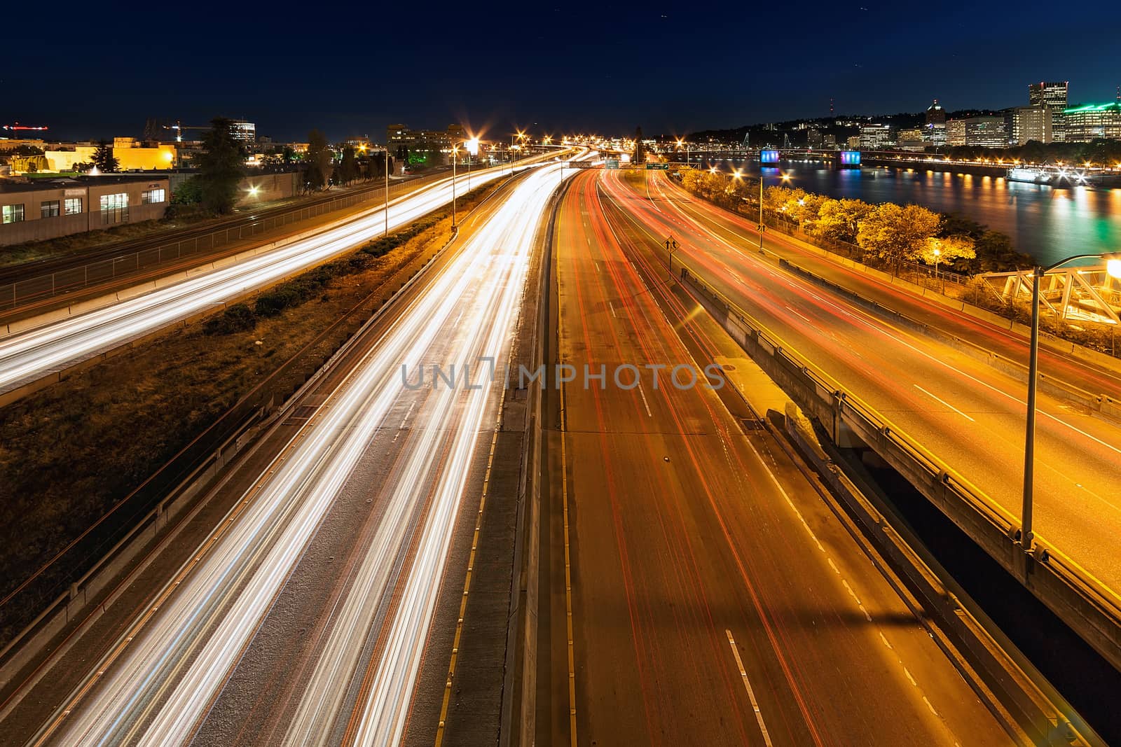 Portland Oregon downtown city skyline and freeway light trails during evening blue hour