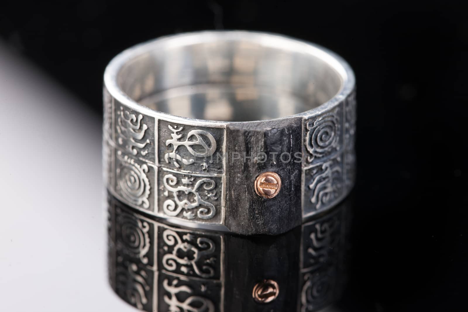 Handmade jewelry on a black glass studio background