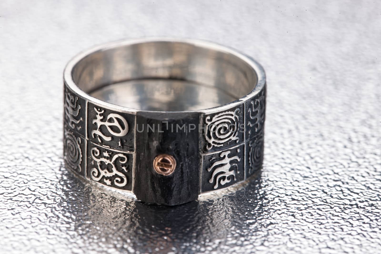 Handmade jewelry on a black glass studio background