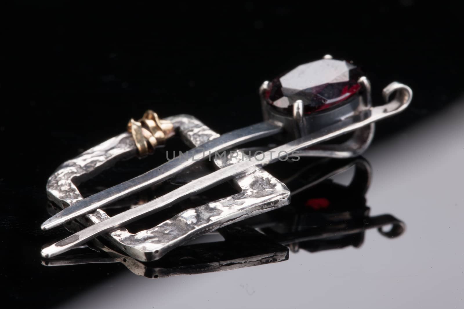 Handmade jewelry on a black glass studio background