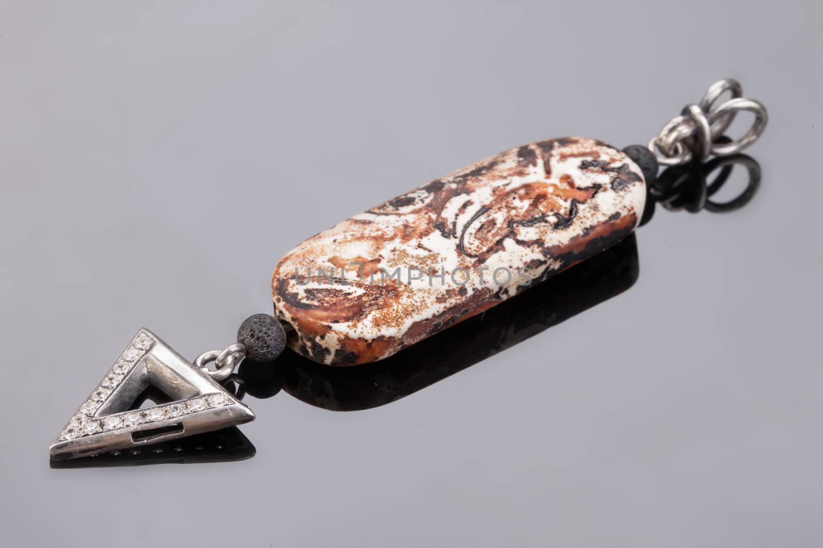 Handmade jewelry on a black glass studio background
