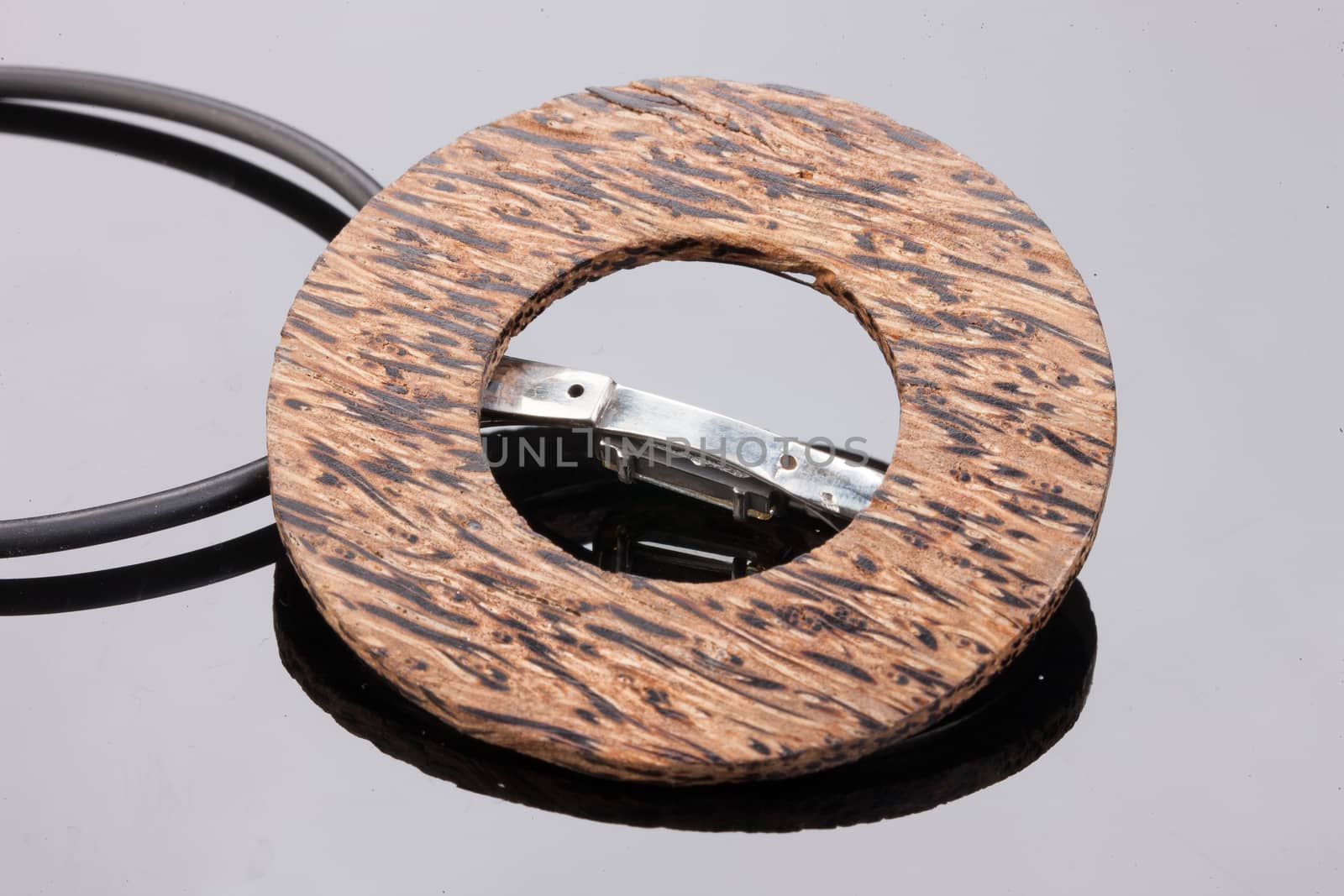 Handmade jewelry on a black glass studio background