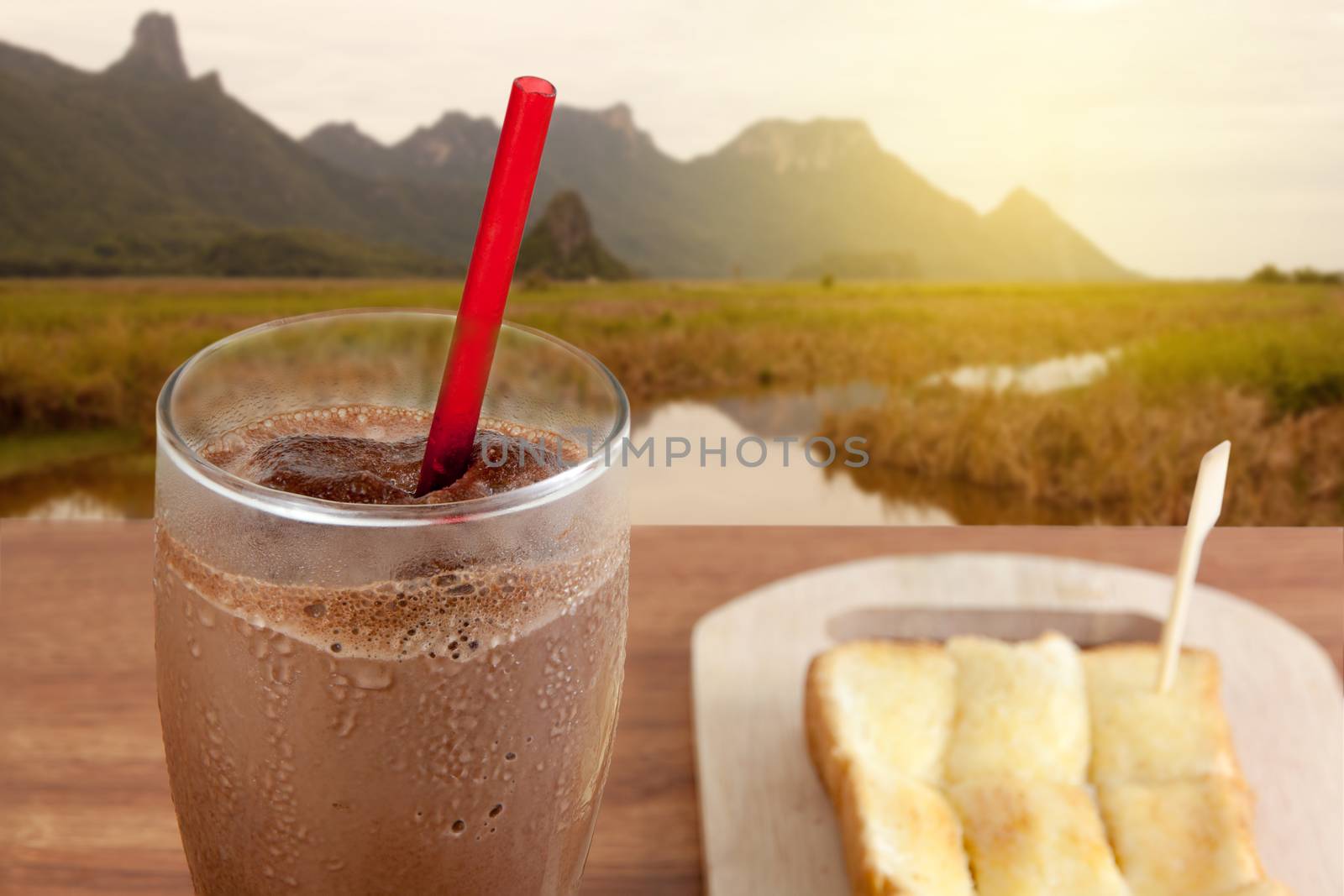 Cocoa chocolate smoothie in glass and Buttered bread in the morning.