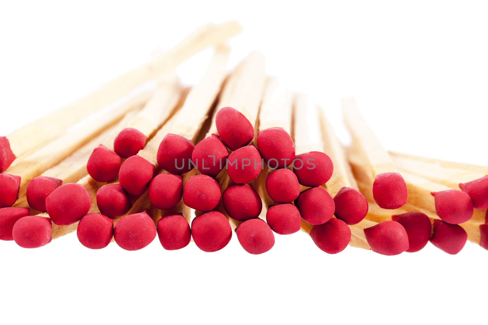 Heap of matches with rad heads isolated on white background, close up