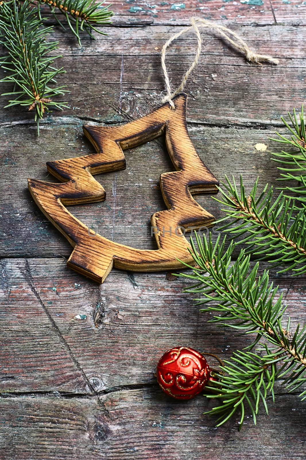Christmas toy, vintage wooden Christmas tree on background with Christmas fir