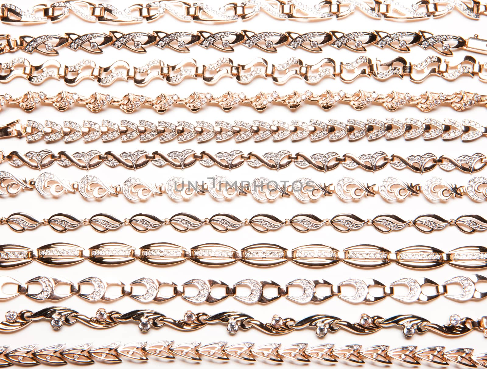 Golden bracelets and violin on isolated white background