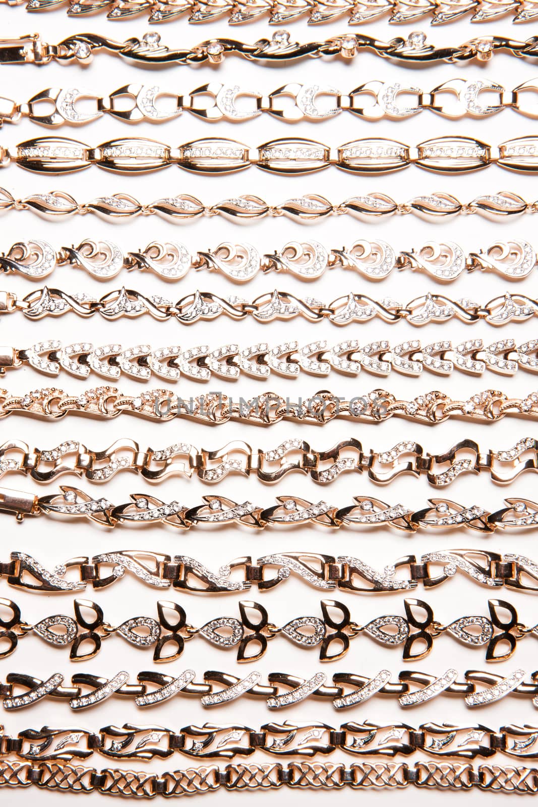 Golden bracelets and violin on isolated white background