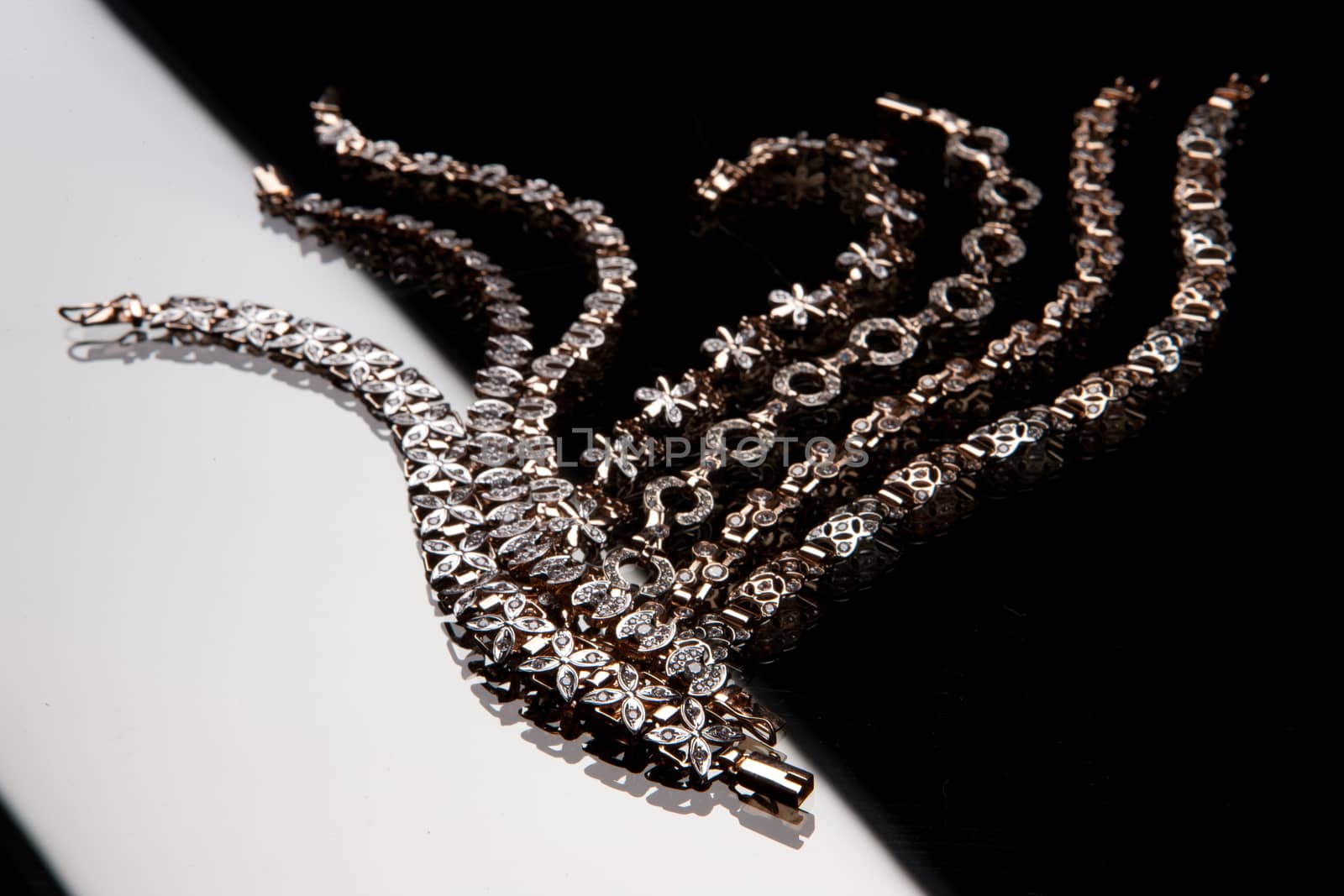 Golden bracelets on a studio background