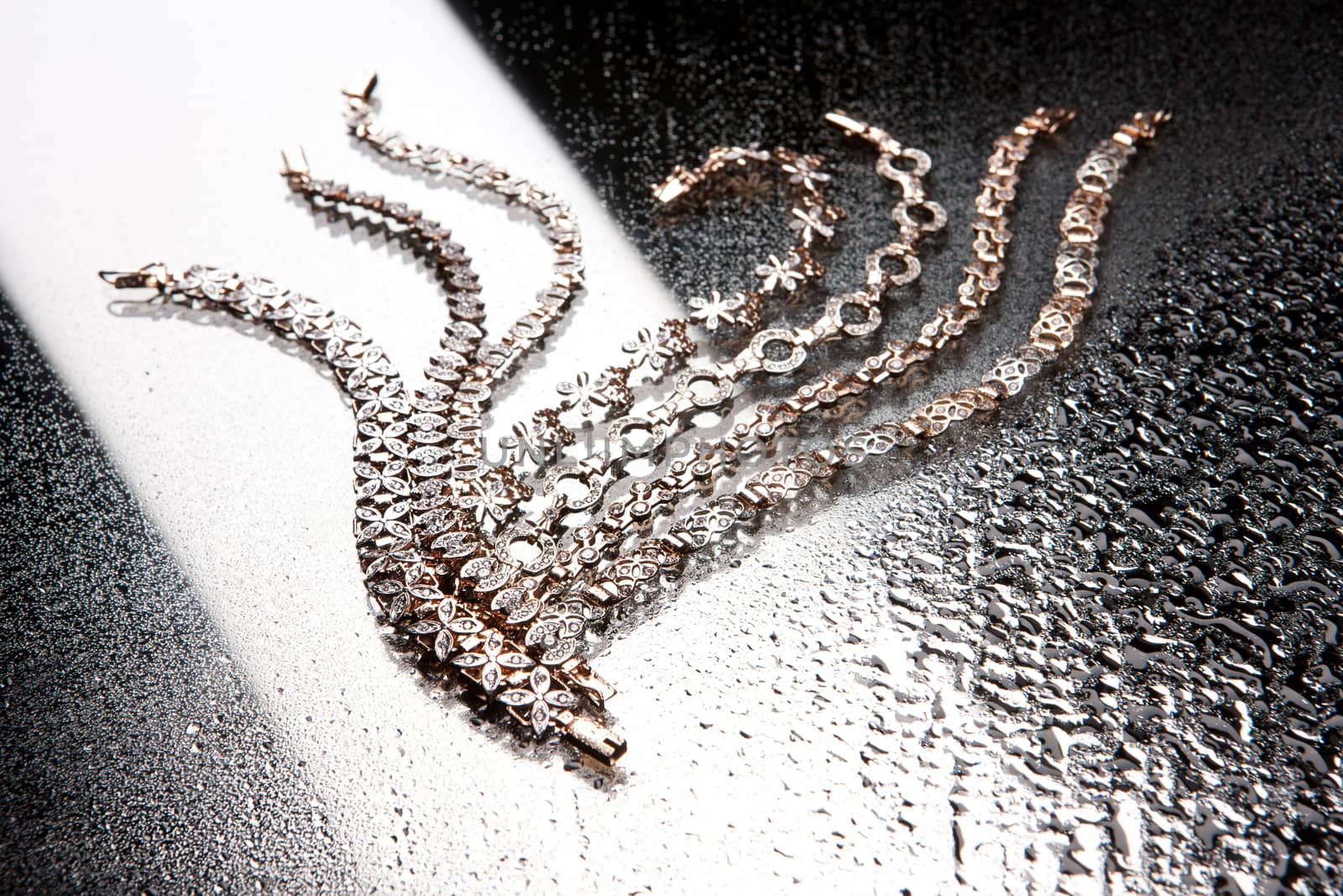Golden bracelets on a studio background