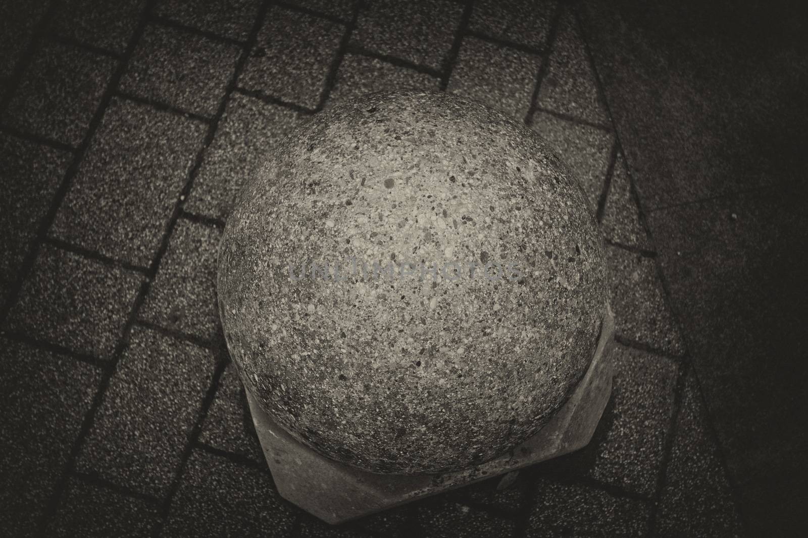 Cement ball on the ground by mariephotos