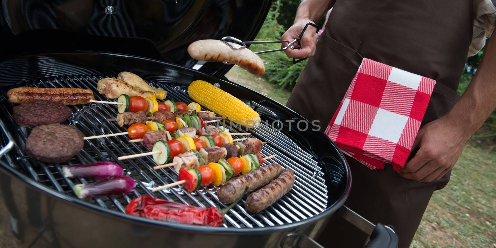 Family having a barbecue party in their garden by FreeProd