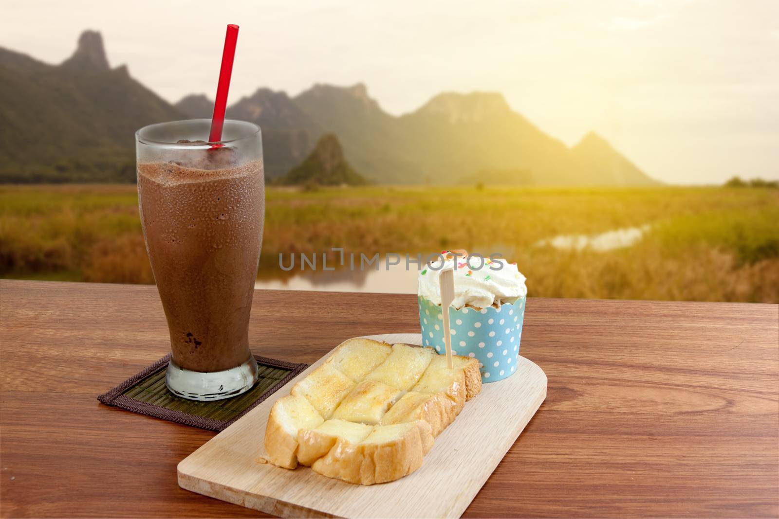 Cocoa chocolate smoothie in glass and Buttered bread and cup cake