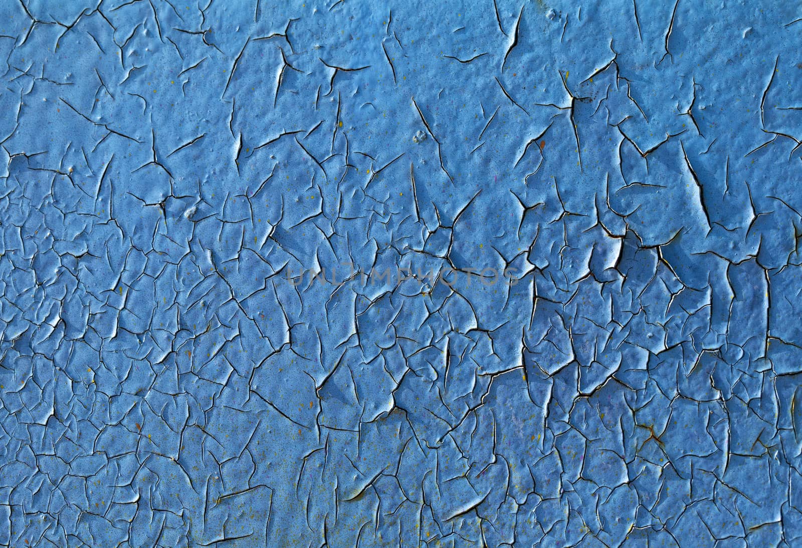 Close-up of peeling paint and rust on a wall