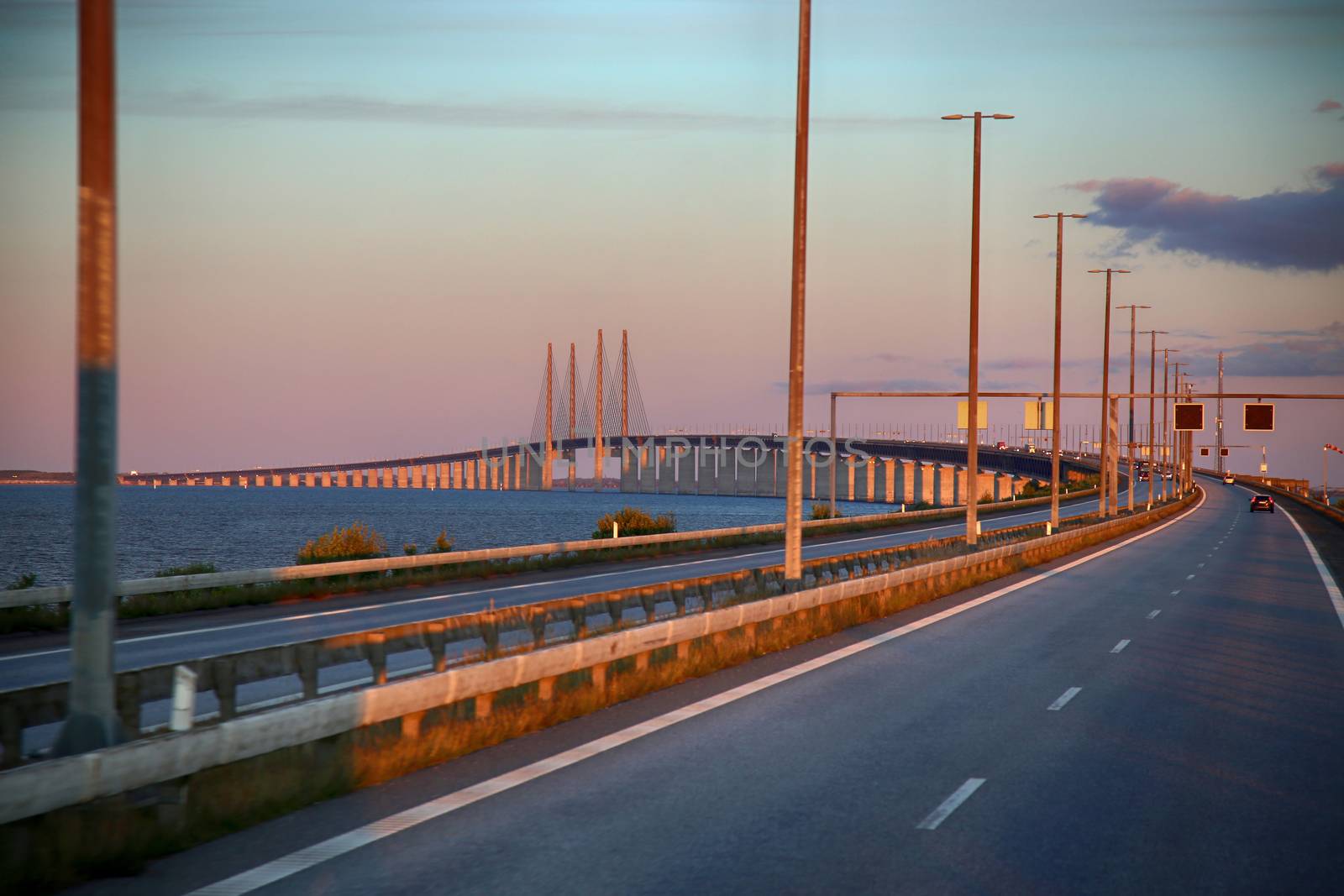 View on Oresund bridge between Sweden and Denmark at sunset by vladacanon