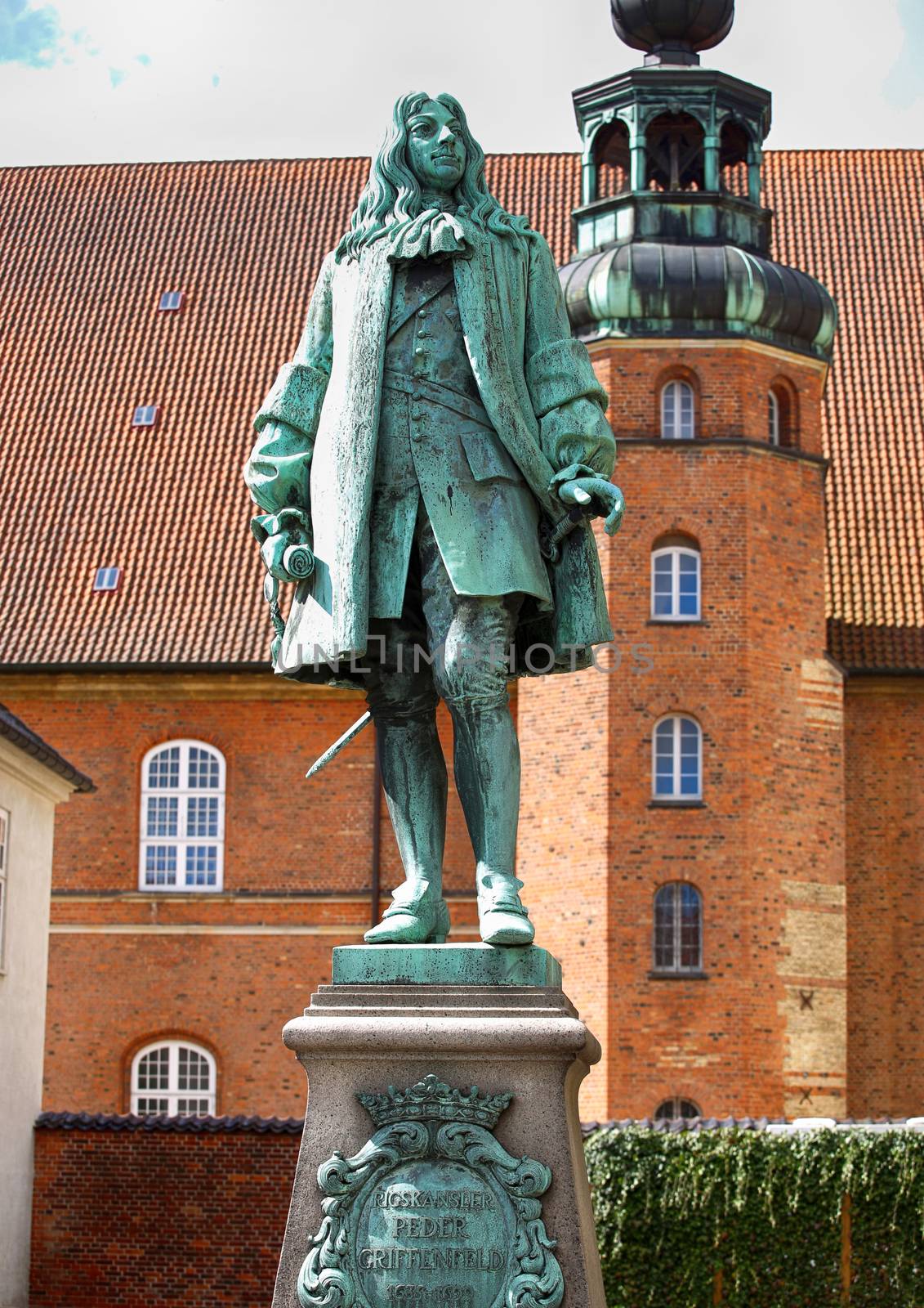 The statue of Chancellor Peder Griffenfeld and a tower in Copenhagen, Denmark