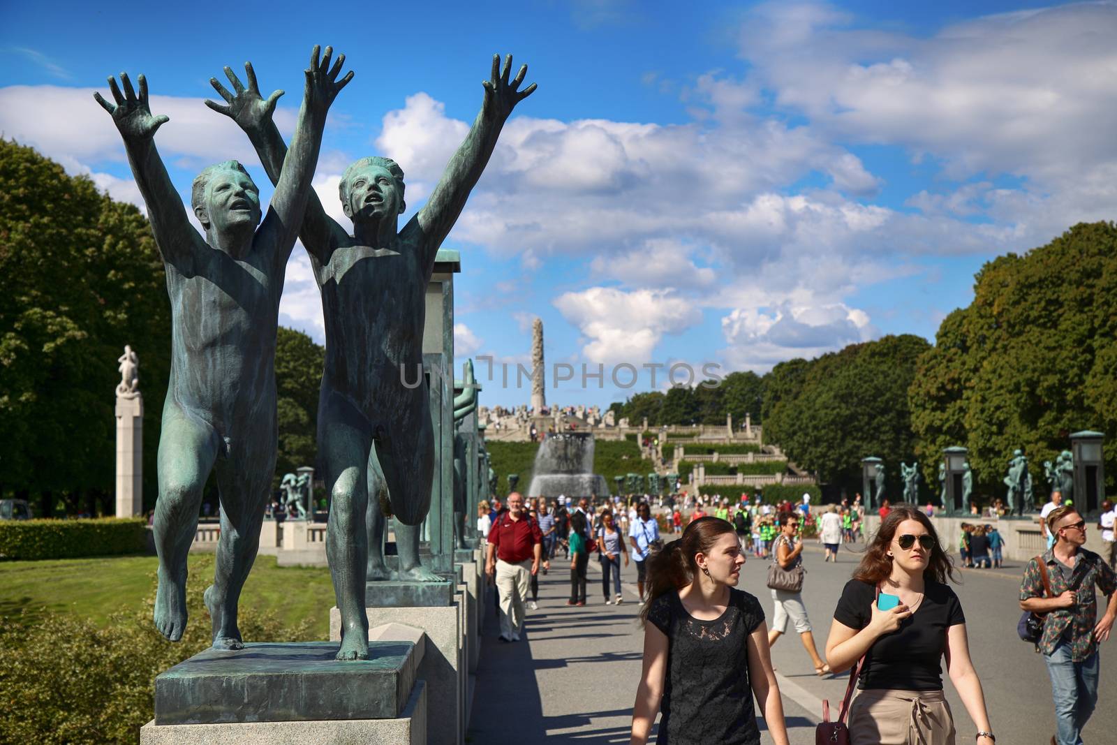 EDITORIAL OSLO, NORWAY - AUGUST 18, 2016: Many tourist walk Vigeland Sculptures Park in the popular Vigeland park ( Frogner Park ), designed by Gustav Vigeland in Oslo, Norway on August 18, 2016. 