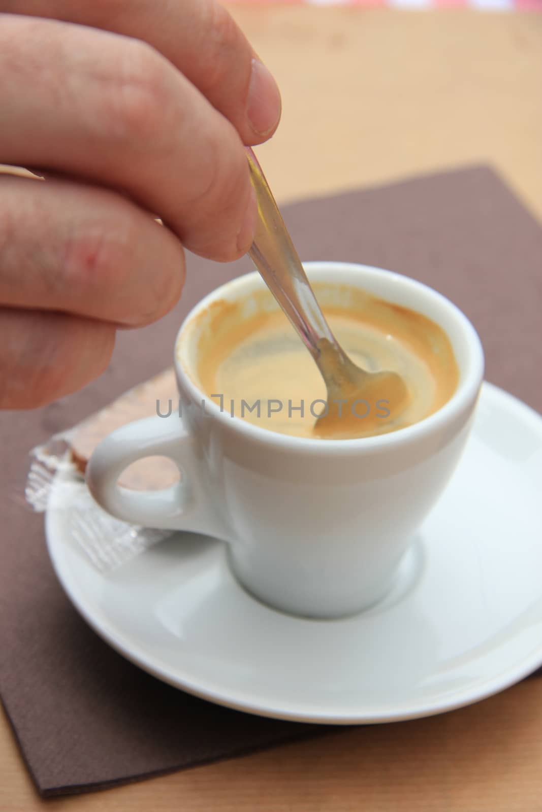 Man stiring an espresso