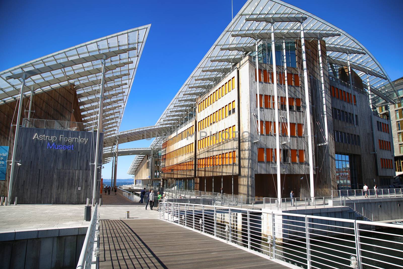 OSLO, NORWAY – AUGUST 17, 2016: View on modern museum Astrup Fearnley Museum from small bridge Strandpromenaden, built as part of Tjuvholmen, designed by Renzo Piano in Oslo, Norway on August 17,2016.