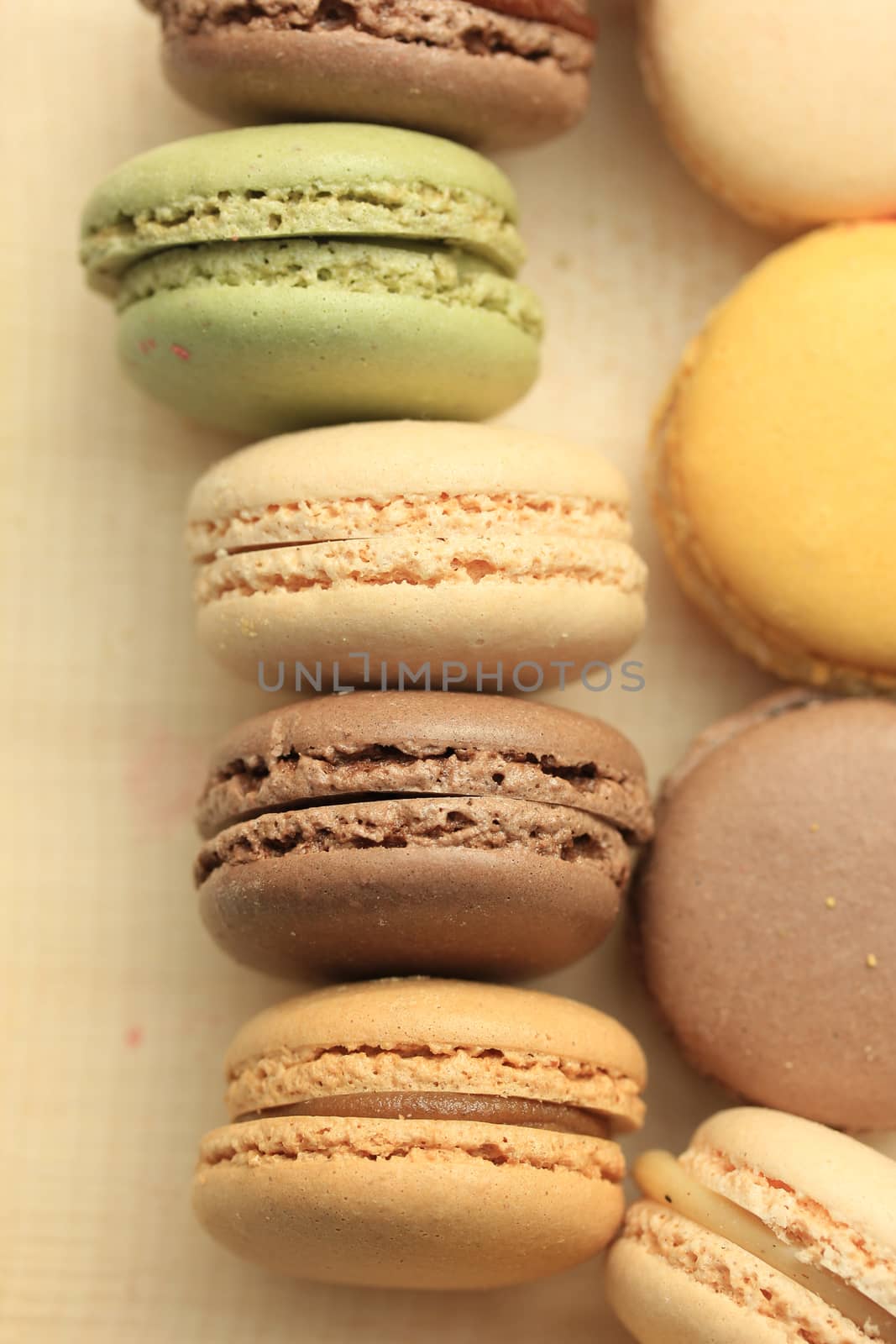 Macarons in different colors and flavors on a wooden cutboard