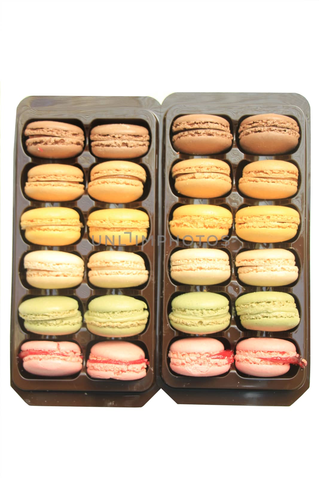 Macarons in different colors and flavors in a plastic tray
