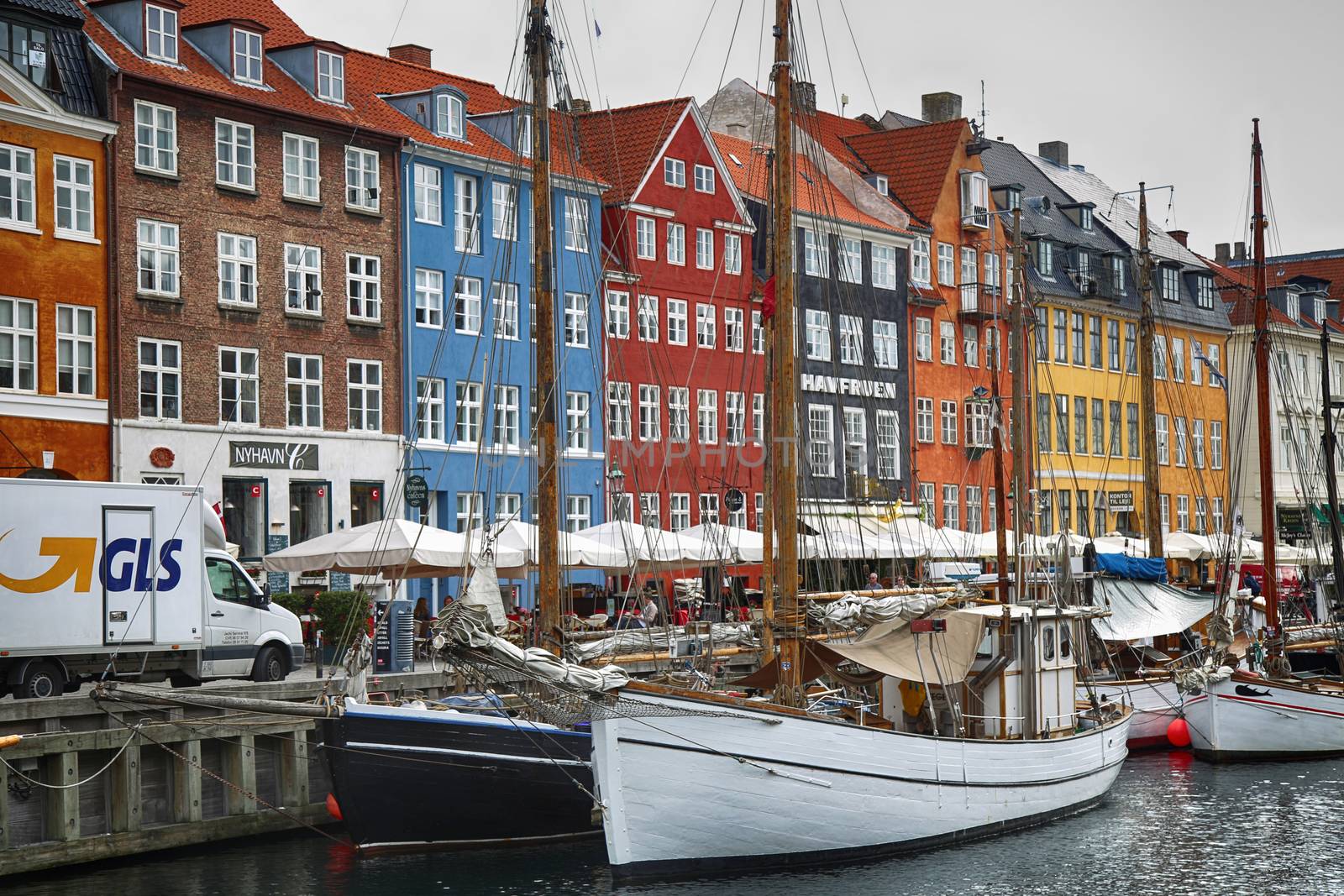 COPENHAGEN, DENMARK - AUGUST 15, 2016: Boats in the docks Nyhavn by vladacanon
