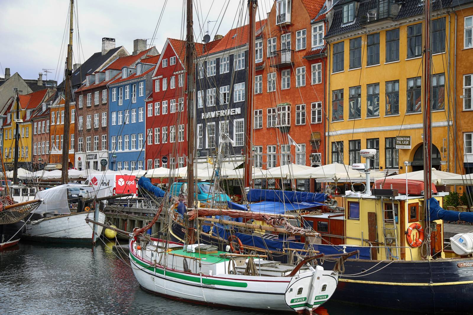 COPENHAGEN, DENMARK - AUGUST 15, 2016: Boats in the docks Nyhavn by vladacanon