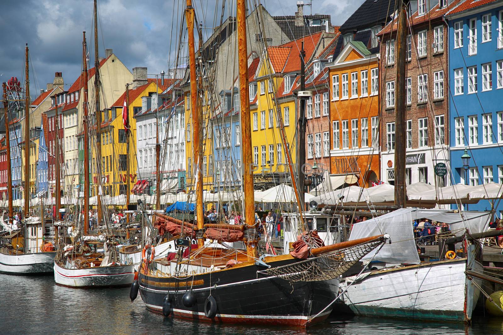 COPENHAGEN, DENMARK - AUGUST 14, 2016: Boats in the docks Nyhavn by vladacanon