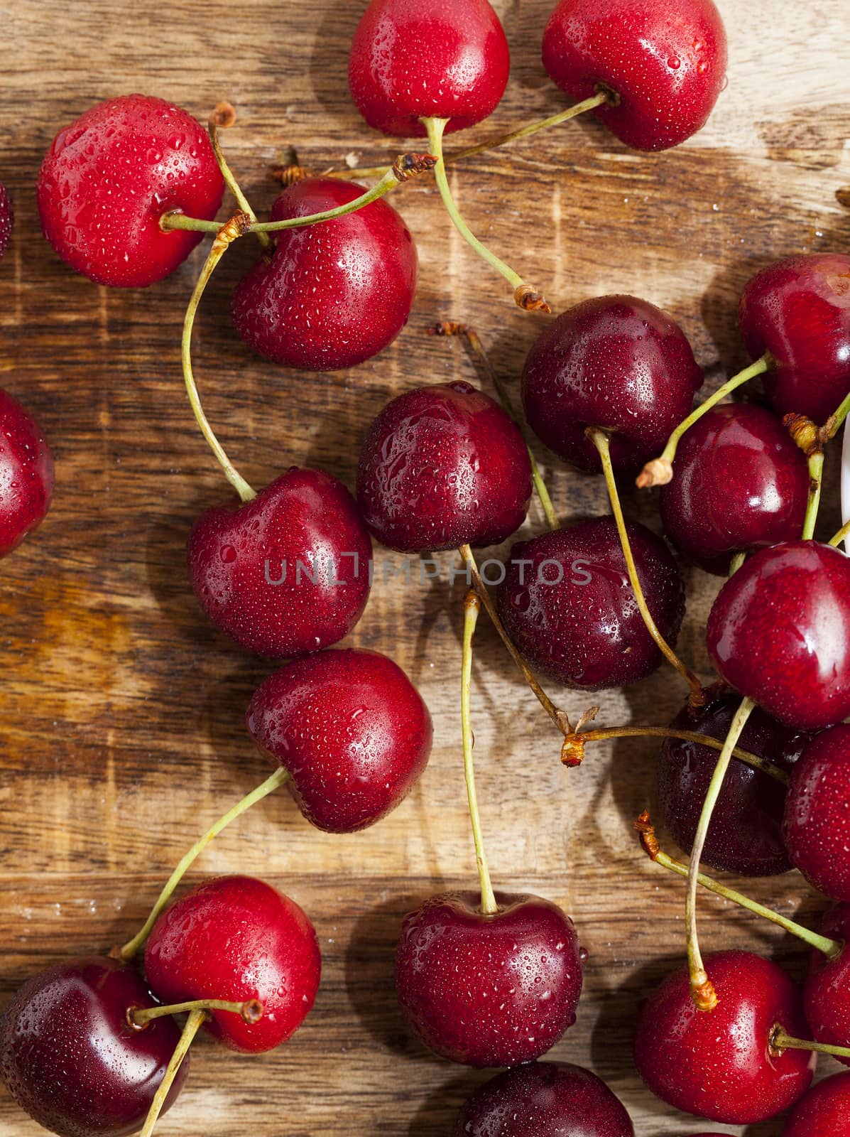 photographed close-up of ripe red cherries covered with water drops, shallow depth of field