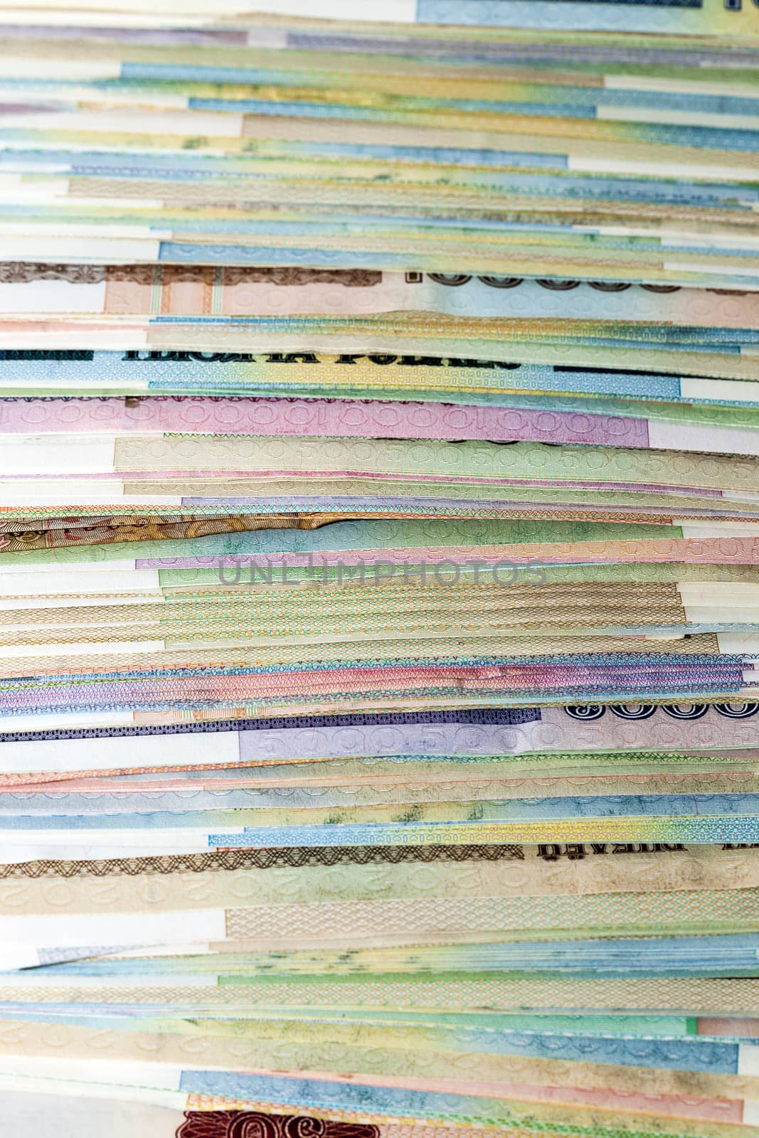 close-up photo of the Belarusian side of the money stacked in a large pile