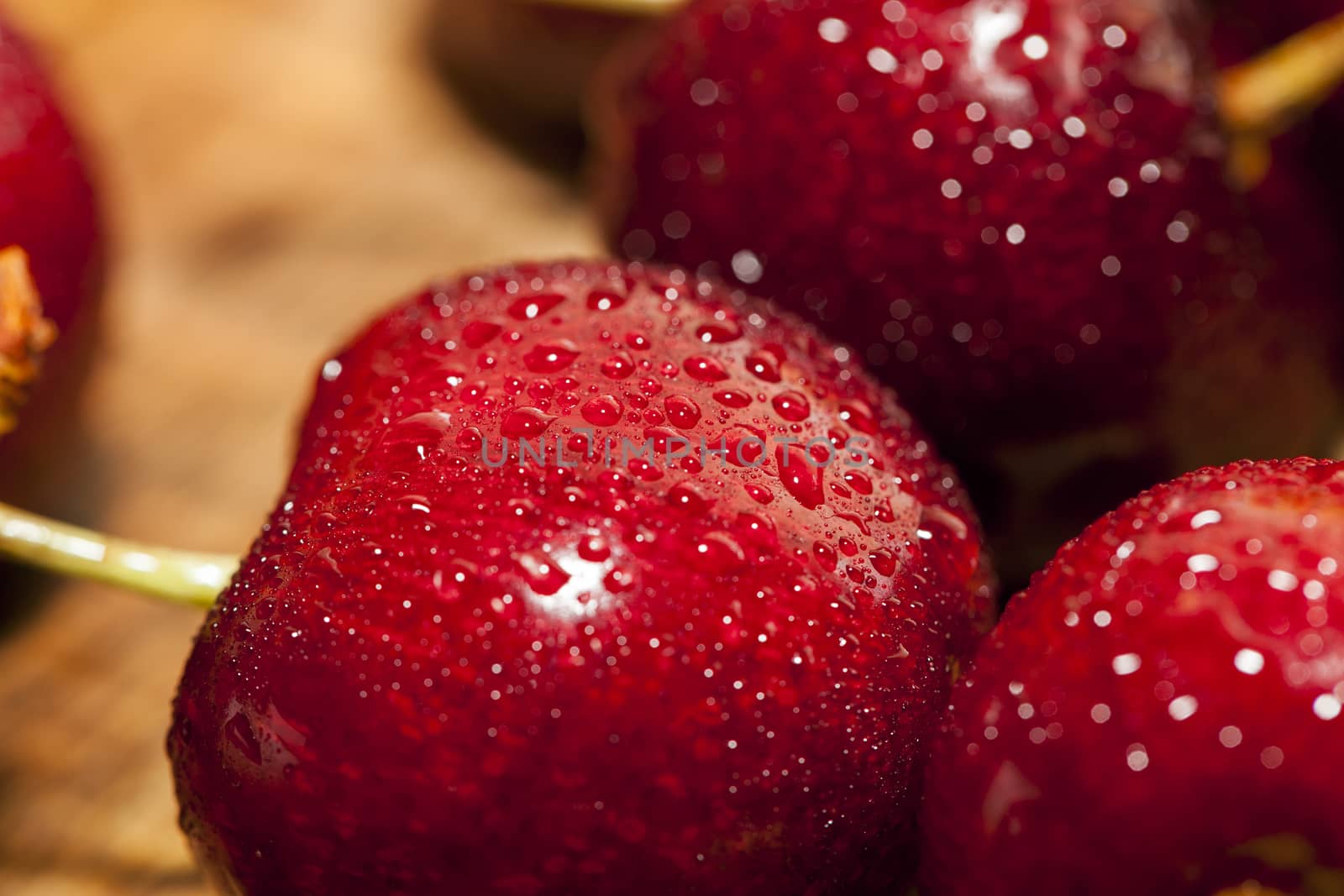 photographed close-up of ripe red cherries covered with water drops, shallow depth of field