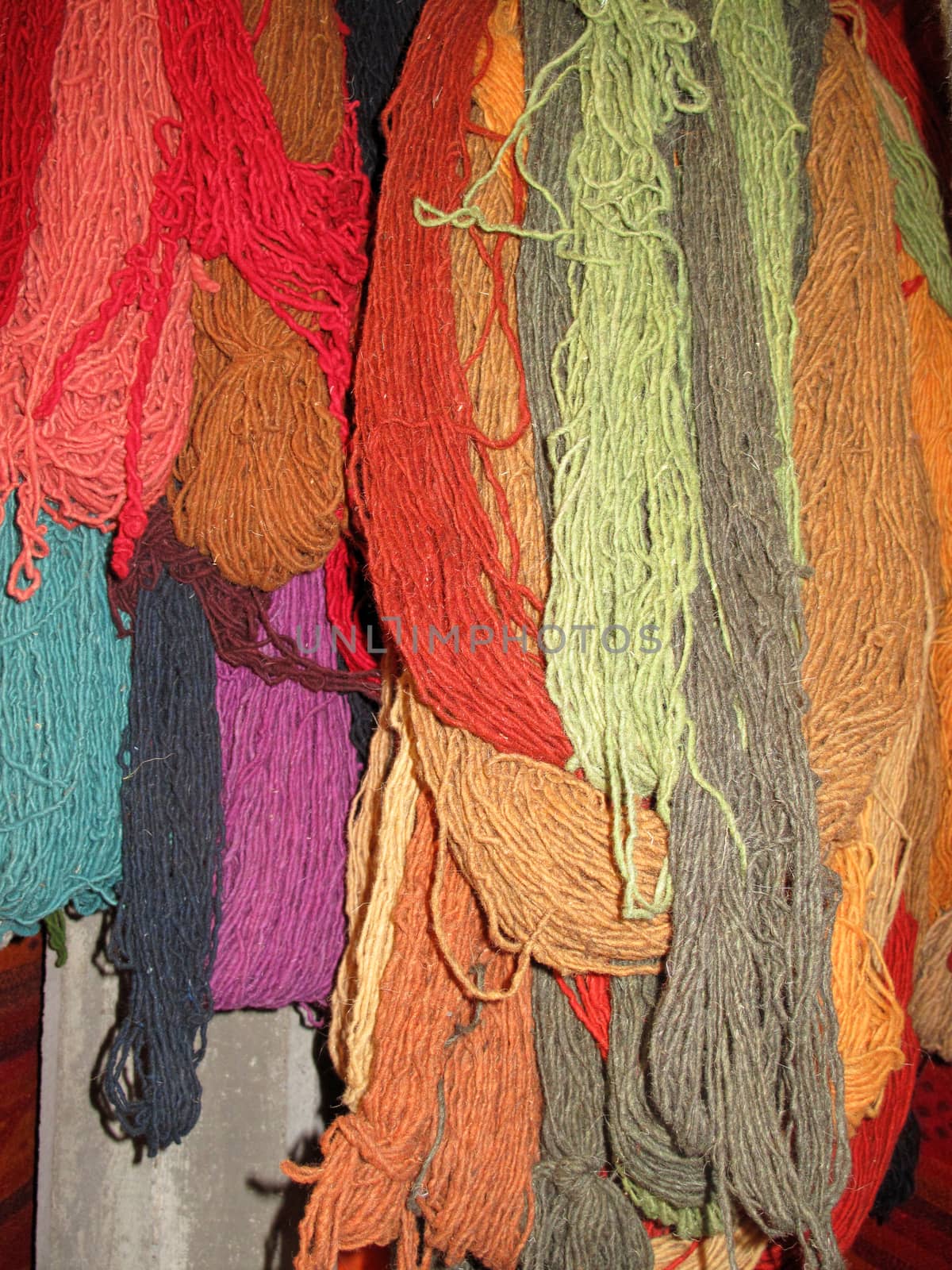 Bundles of dyed colorful wool, Mexico by cicloco