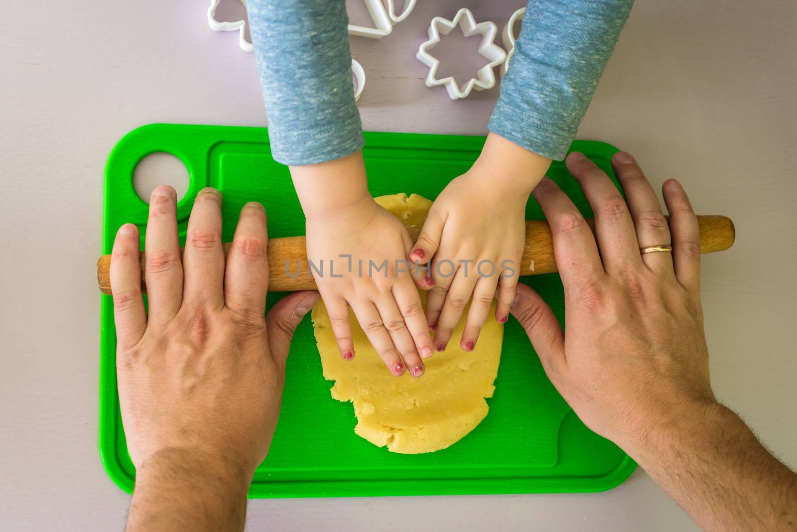 Children and dad hands rolled shortcrust dough by okskukuruza