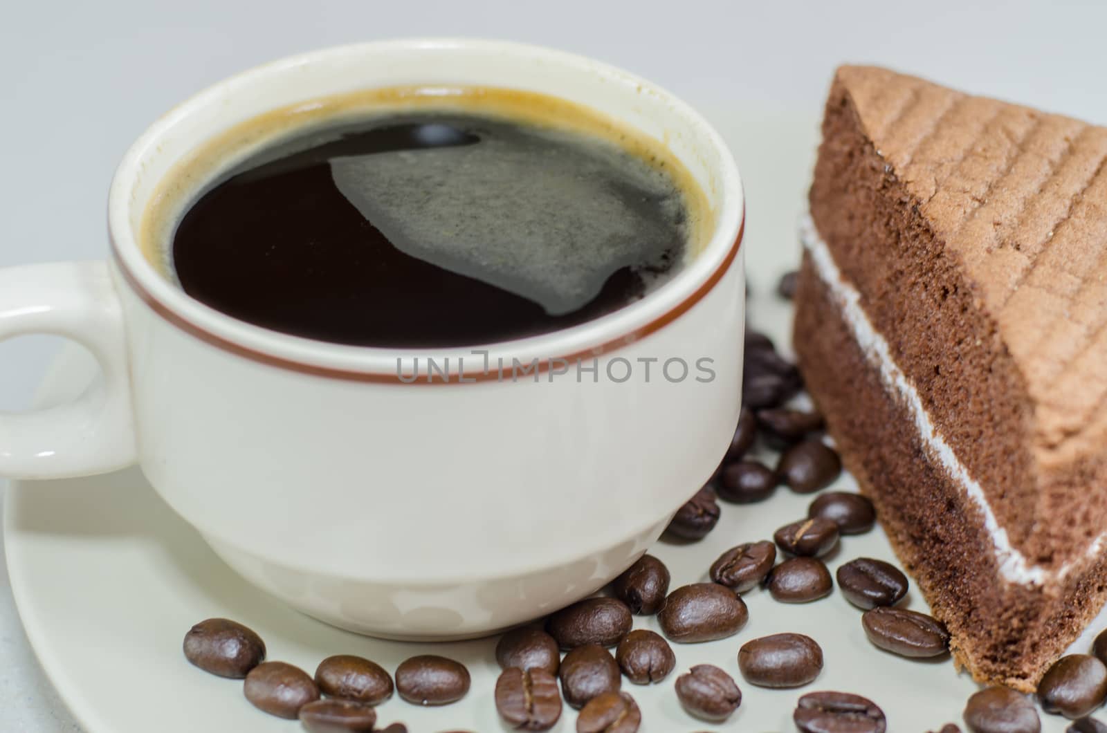 A cup of coffee with slice of chocolate cake on White background by metal22