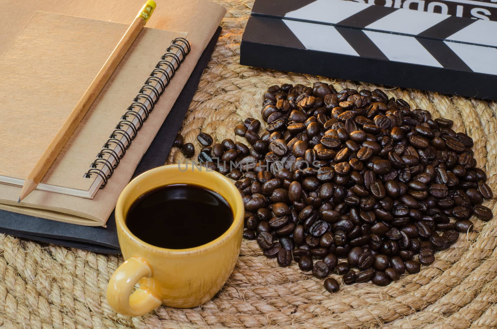 Cup of coffee with  notebook slate on a jute rope.